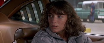 Movie still from “Starman” (1984), directed by John Carpenter – A person wearing a jacket; Close Up shot, Over the shoulder angle