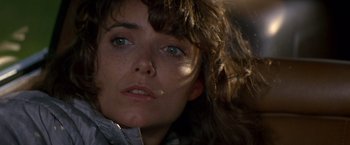 Movie still from “Starman” (1984), directed by John Carpenter – A woman's face in the sunlight; Close Up shot, Over the shoulder angle