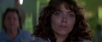 Movie still from “Starman” (1984), directed by John Carpenter – A woman's face in a dark room; Close Up shot, Low angle