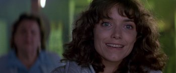 Movie still from “Starman” (1984), directed by John Carpenter – A woman's face with a smile on her face; Close Up shot, Over the shoulder angle