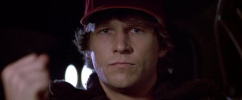 Movie still from “Starman” (1984), directed by John Carpenter – A person wearing a hat; Close Up shot, Low angle