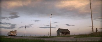 Movie still from “Starman” (1984), directed by John Carpenter – An old house on the side of the road near a telephone pole; Extreme Wide shot, Low angle