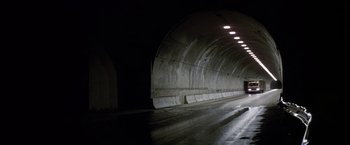 Movie still from “Starman” (1984), directed by John Carpenter – An empty tunnel with a light at the end of the tunnel; Extreme Wide shot, High angle