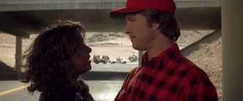 Movie still from “Starman” (1984), directed by John Carpenter – A man and a woman looking at one another; Close Up shot, Over the shoulder angle