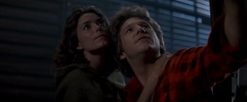 Movie still from “Starman” (1984), directed by John Carpenter – A man and a woman looking up into the sky; Close Up shot, Low angle