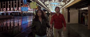 Movie still from “Starman” (1984), directed by John Carpenter – A man and a woman walking down a street; Wide shot, Low angle
