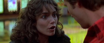 Movie still from “Starman” (1984), directed by John Carpenter – A person looking at the camera; Close Up shot, Over the shoulder angle