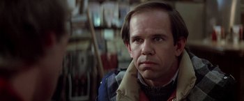 Movie still from “Starman” (1984), directed by John Carpenter – A person wearing a jacket; Close Up shot, Over the shoulder angle