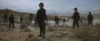 Movie still from “Starman” (1984), directed by John Carpenter – A group of soldiers in the middle of the desert; Wide shot, Low angle