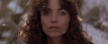 Movie still from “Starman” (1984), directed by John Carpenter – A woman's face with a lot of hair on her face; Close Up shot, Low angle