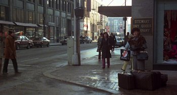 Movie still from “Stripes” (1981), directed by Ivan Reitman – A group of people walking down a street; Wide shot, High angle