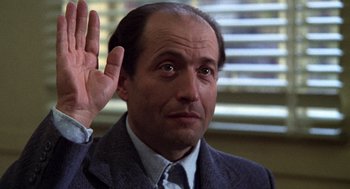 Movie still from “Stripes” (1981), directed by Ivan Reitman – A person holding his hand up; Close Up shot, Low angle