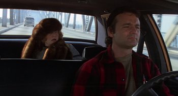Movie still from “Stripes” (1981), directed by Ivan Reitman – A man and a child in a car; Close Up shot, Over the shoulder angle