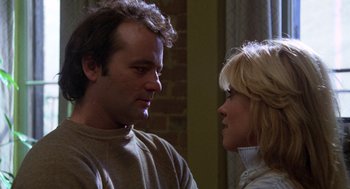 Movie still from “Stripes” (1981), directed by Ivan Reitman – A man and a woman standing next to each other; Close Up shot, Low angle