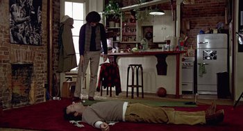 Movie still from “Stripes” (1981), directed by Ivan Reitman – A man lying on the ground next to a woman; Wide shot, High angle