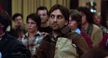 Movie still from “Stripes” (1981), directed by Ivan Reitman – A group of people sitting in a room; Close Up shot, Over the shoulder angle