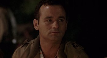 Movie still from “Stripes” (1981), directed by Ivan Reitman – A person wearing a jacket looking at the camera; Close Up shot, Over the shoulder angle