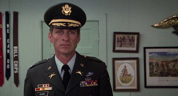 Movie still from “Stripes” (1981), directed by Ivan Reitman – A man in a military uniform standing in front of a wall; Close Up shot, Low angle