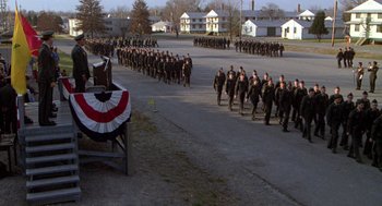 Movie still from “Stripes” (1981), directed by Ivan Reitman – A group of men in uniform marching down a street; Wide shot, High angle