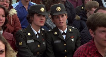 Movie still from “Stripes” (1981), directed by Ivan Reitman – A couple of women in military uniforms sitting next to each other; Medium shot, Over the shoulder angle
