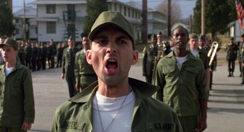 Movie still from “Stripes” (1981), directed by Ivan Reitman – A group of men in green fatigues marching down a street; Close Up shot, Low angle