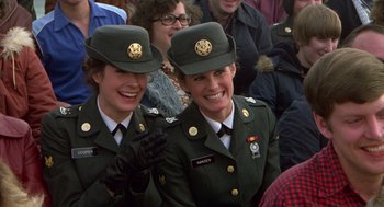 Movie still from “Stripes” (1981), directed by Ivan Reitman – A couple of women in army fatigues and hats; Medium shot, Over the shoulder angle