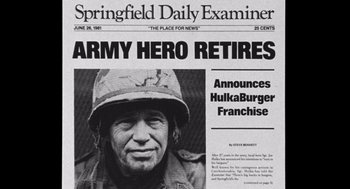 Movie still from “Stripes” (1981), directed by Ivan Reitman – A newspaper with a picture of a man in a military uniform; Extreme Close Up shot, Over the shoulder angle