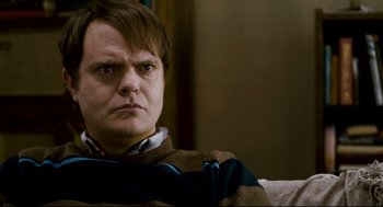 Movie still from “Super” (2010), directed by James Gunn – A person sitting on a couch; Close Up shot, Over the shoulder angle