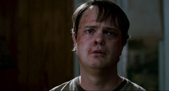 Movie still from “Super” (2010), directed by James Gunn – A person looking at the camera; Close Up shot, Over the shoulder angle