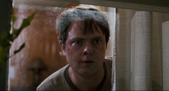 Movie still from “Super” (2010), directed by James Gunn – A person looking at the camera; Close Up shot, Over the shoulder angle