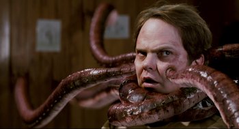 Movie still from “Super” (2010), directed by James Gunn – A man with a tentacled face and tentacles around his neck; Close Up shot, Over the shoulder angle