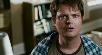 Movie still from “Super” (2010), directed by James Gunn – A person looking at the camera; Close Up shot, High angle
