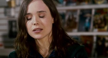 Movie still from “Super” (2010), directed by James Gunn – A person with her eyes closed; Close Up shot, Over the shoulder angle