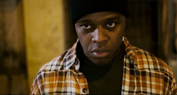 Movie still from “Super” (2010), directed by James Gunn – A person wearing a plaid shirt; Close Up shot, Low angle