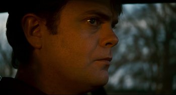 Movie still from “Super” (2010), directed by James Gunn – A man's face in the dark; Close Up shot, Low angle