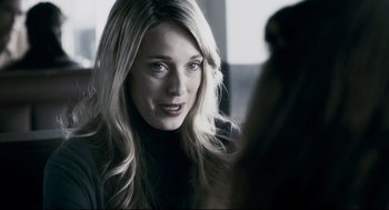 Movie still from “Super” (2010), directed by James Gunn – A beautiful blonde woman with long hair looking at the camera; Close Up shot, Over the shoulder angle