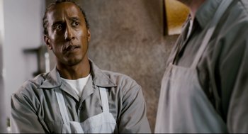 Movie still from “Super” (2010), directed by James Gunn – A person wearing an overalls; Close Up shot, Low angle