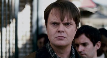 Movie still from “Super” (2010), directed by James Gunn – A person wearing a plaid shirt; Close Up shot, Over the shoulder angle
