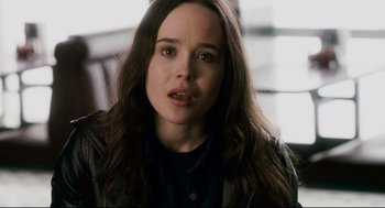 Movie still from “Super” (2010), directed by James Gunn – A person with long brown hair; Close Up shot, Over the shoulder angle