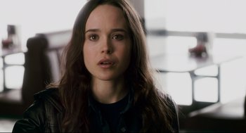 Movie still from “Super” (2010), directed by James Gunn – A person with long brown hair; Close Up shot, Over the shoulder angle
