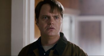 Movie still from “Super” (2010), directed by James Gunn – A person wearing a brown jacket; Close Up shot, Over the shoulder angle