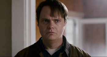 Movie still from “Super” (2010), directed by James Gunn – A person wearing a brown jacket; Close Up shot, Over the shoulder angle