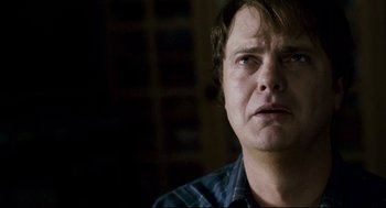 Movie still from “Super” (2010), directed by James Gunn – A person with his eyes wide open; Close Up shot, Over the shoulder angle