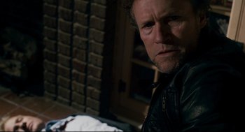 Movie still from “Super” (2010), directed by James Gunn – A person wearing a leather jacket; Close Up shot, High angle