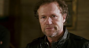 Movie still from “Super” (2010), directed by James Gunn – A person wearing a leather jacket; Close Up shot, Low angle