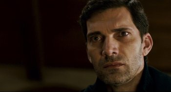 Movie still from “Super” (2010), directed by James Gunn – A man's face looking at the camera; Close Up shot, Over the shoulder angle