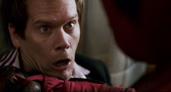 Movie still from “Super” (2010), directed by James Gunn – A person wearing a suit and tie; Close Up shot, Overhead angle