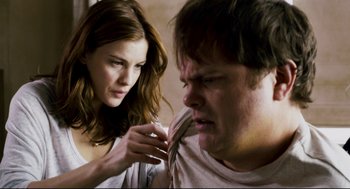 Movie still from “Super” (2010), directed by James Gunn – A woman is helping a man with his tie; Close Up shot, Over the shoulder angle