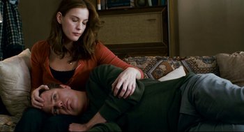 Movie still from “Super” (2010), directed by James Gunn – A man and a woman laying on a couch; Medium shot, High angle