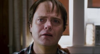 Movie still from “Super” (2010), directed by James Gunn – A person with his eyes wide open; Close Up shot, Over the shoulder angle